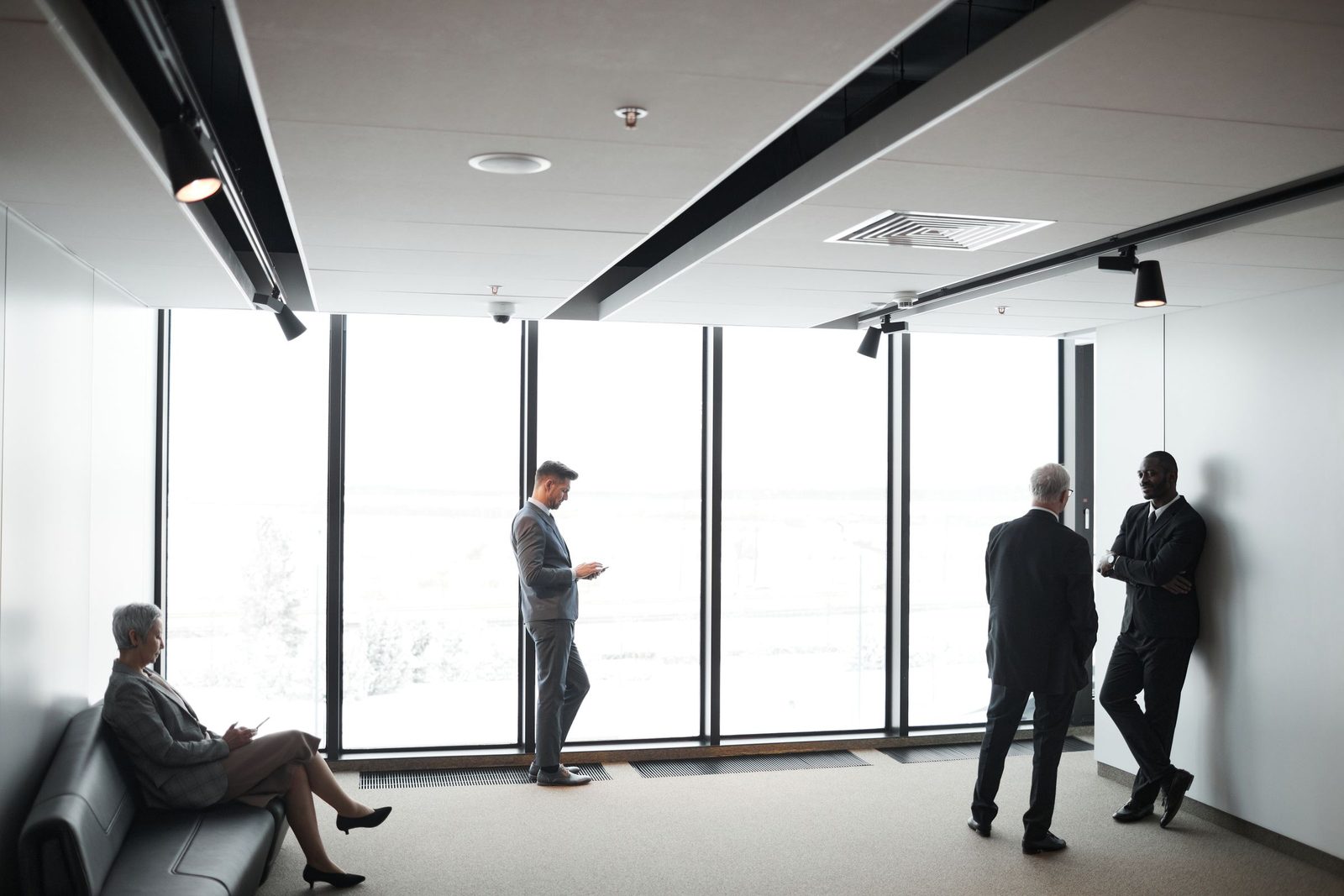 Senior executives in conversation in a modern corporate office
