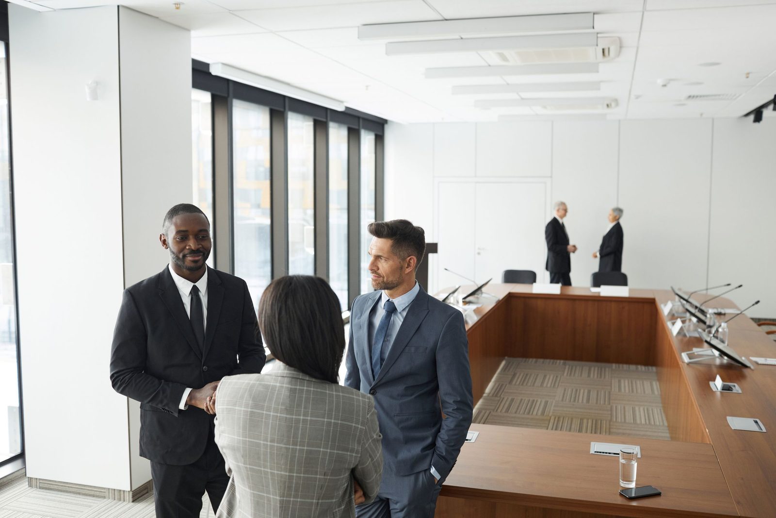 Senior executives conferring in a boardroom before a decision