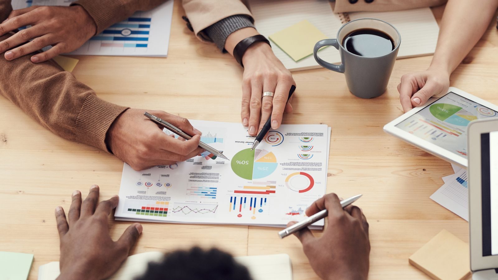Leaders reviewing performance metrics and coaching ROI data